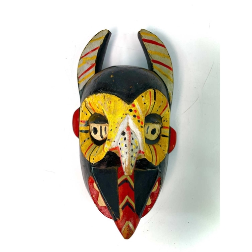 257 - An African wood carved Igbo mask painted in polychrome colours, height 31cm, together with another f... 