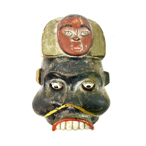 257 - An African wood carved Igbo mask painted in polychrome colours, height 31cm, together with another f... 