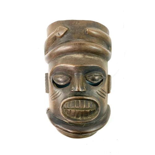 257 - An African wood carved Igbo mask painted in polychrome colours, height 31cm, together with another f... 