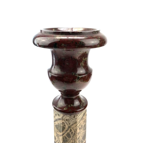 27 - A Cornish serpentine candlestick, raised on a banded octagonal column and turned base, height 28.5cm... 