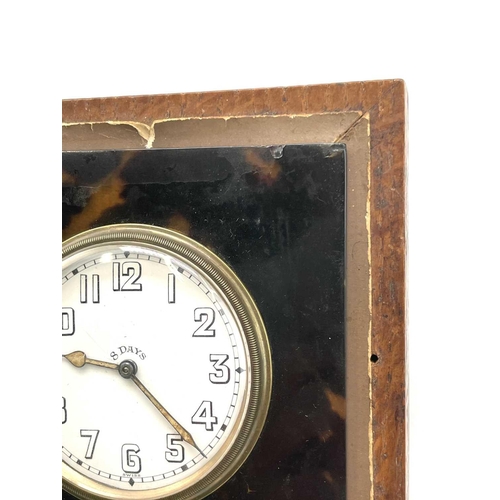 273 - An 8 day travel clock, in a faux tortoiseshell surround, in an oak case, 12.5cm square.