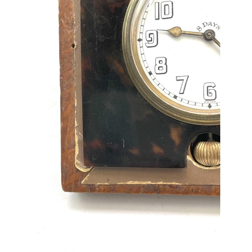 273 - An 8 day travel clock, in a faux tortoiseshell surround, in an oak case, 12.5cm square.