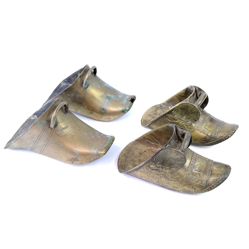 279 - A pair of South American brass stirrups, length 23cm together another pair of brass stirrups, a bras... 