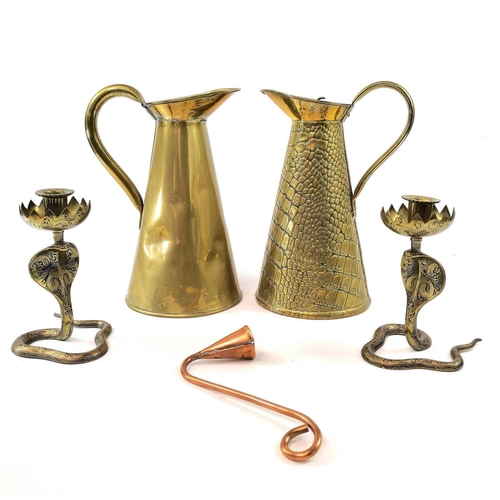 283 - A pair of Indian brass cobra candle holders, height 17cm together with two brass jugs and a copper c... 