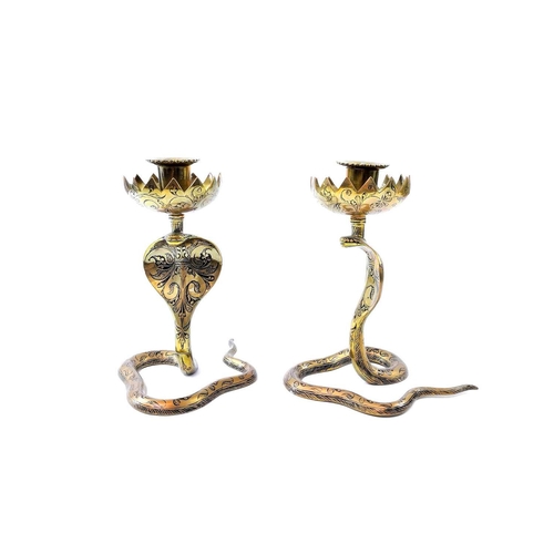 283 - A pair of Indian brass cobra candle holders, height 17cm together with two brass jugs and a copper c... 