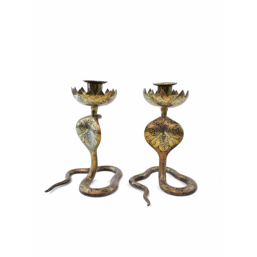 283 - A pair of Indian brass cobra candle holders, height 17cm together with two brass jugs and a copper c... 