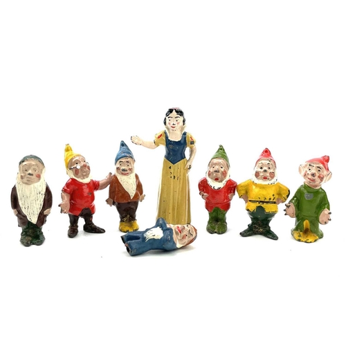 31 - A painted lead Snow White figure, height 6cm, and the seven Dwarves.