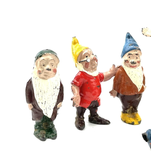 31 - A painted lead Snow White figure, height 6cm, and the seven Dwarves.