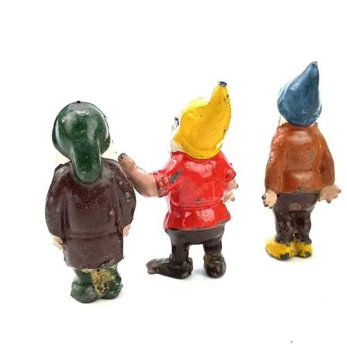 31 - A painted lead Snow White figure, height 6cm, and the seven Dwarves.