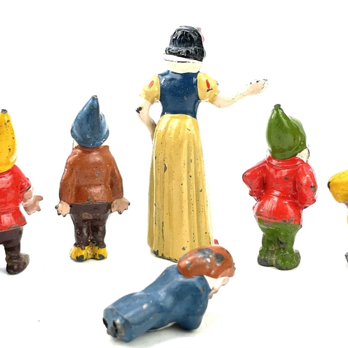 31 - A painted lead Snow White figure, height 6cm, and the seven Dwarves.