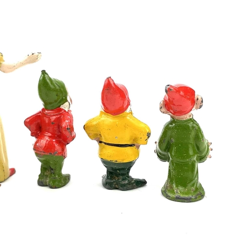 31 - A painted lead Snow White figure, height 6cm, and the seven Dwarves.