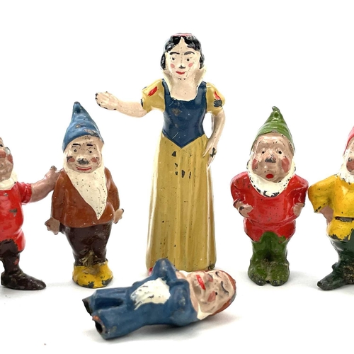 31 - A painted lead Snow White figure, height 6cm, and the seven Dwarves.