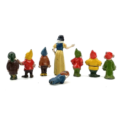 31 - A painted lead Snow White figure, height 6cm, and the seven Dwarves.