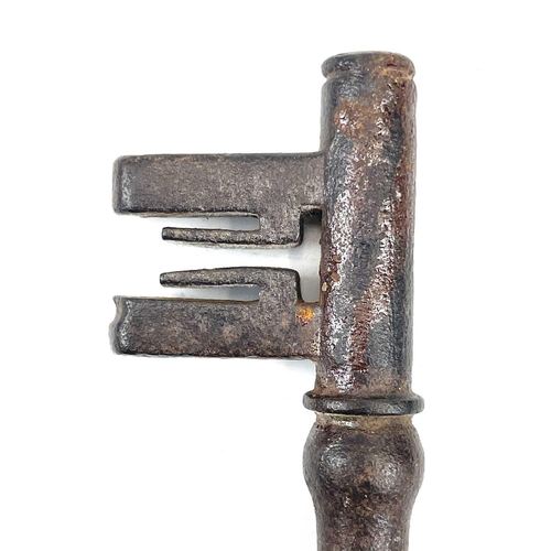 32 - An 18th century iron key, with integral folding ring, length 15cm, together with three other iron ke... 