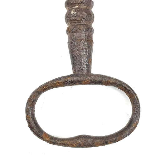 32 - An 18th century iron key, with integral folding ring, length 15cm, together with three other iron ke... 