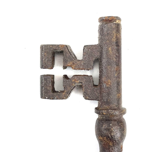 32 - An 18th century iron key, with integral folding ring, length 15cm, together with three other iron ke... 