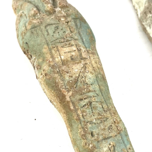 39 - An ancient Egyptian pottery shabti possibly 1570BC-945BC with traces of glaze, length 11cm together ... 