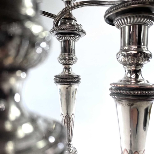 4 - Old Sheffield plate. A Candelabrum and a pair of candlesticks . Early 19th century, of neo-classical... 