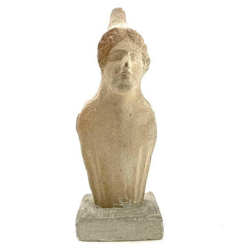 40 - A Cypriot limestone half length votive figure carved with a conical headdress on square plaster base... 