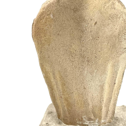 40 - A Cypriot limestone half length votive figure carved with a conical headdress on square plaster base... 