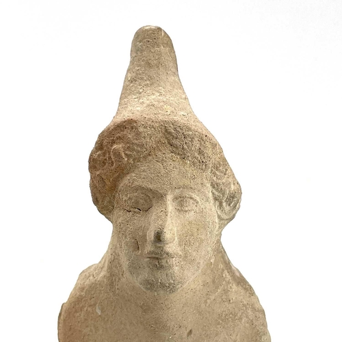 40 - A Cypriot limestone half length votive figure carved with a conical headdress on square plaster base... 