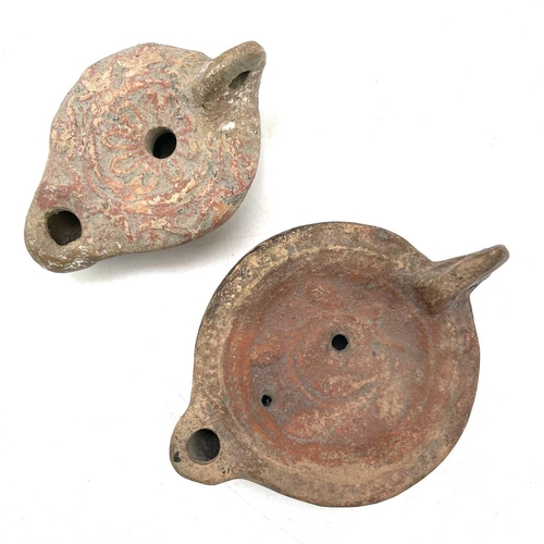 41 - A Roman terracotta oil lamp moulded with wheat design diameter 10cm together with another Roman terr... 