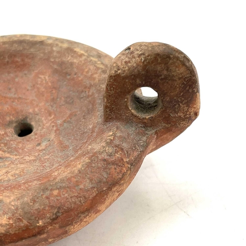 41 - A Roman terracotta oil lamp moulded with wheat design diameter 10cm together with another Roman terr... 