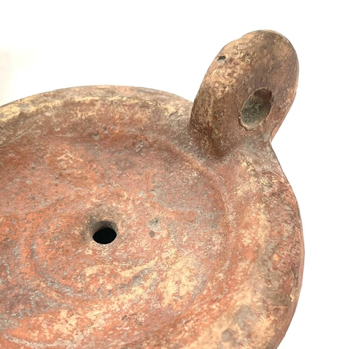 41 - A Roman terracotta oil lamp moulded with wheat design diameter 10cm together with another Roman terr... 