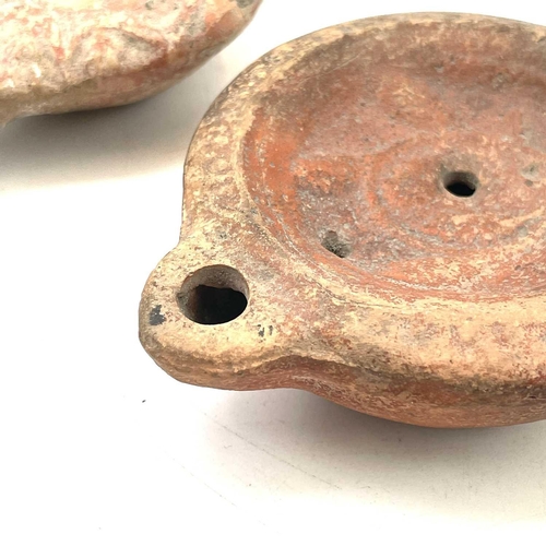 41 - A Roman terracotta oil lamp moulded with wheat design diameter 10cm together with another Roman terr... 