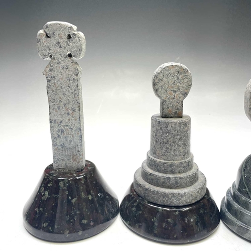 43 - A group of four Cornish serpentine crosses, of various types, each on a turned and polished base, th... 