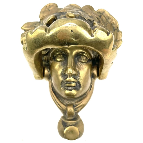 53 - A brass door knocker modelled as a Classical female mask, height 17cm.