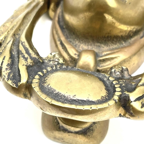 53 - A brass door knocker modelled as a Classical female mask, height 17cm.