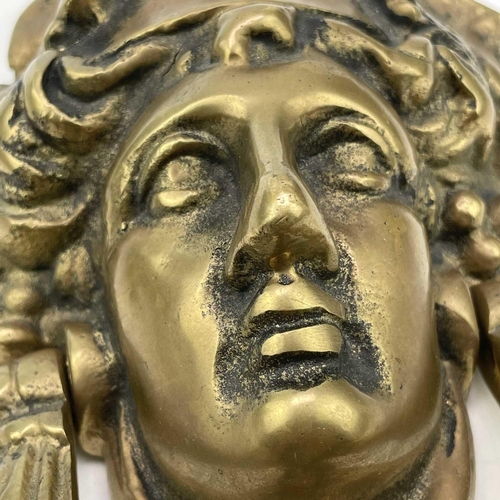 53 - A brass door knocker modelled as a Classical female mask, height 17cm.