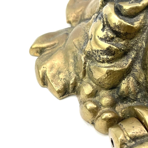 53 - A brass door knocker modelled as a Classical female mask, height 17cm.