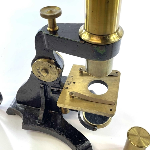 57 - A brass and painted metal microscope, circa 1900, with additional lens and viewer, height 39cm, in a... 