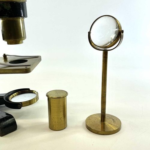 57 - A brass and painted metal microscope, circa 1900, with additional lens and viewer, height 39cm, in a... 