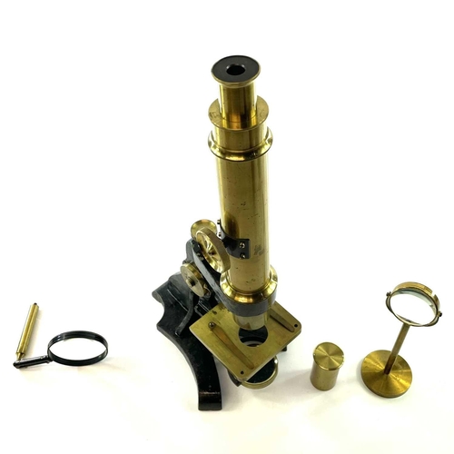 57 - A brass and painted metal microscope, circa 1900, with additional lens and viewer, height 39cm, in a... 