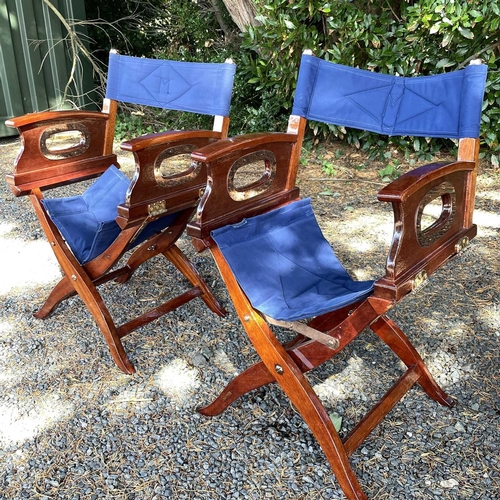 604 - Three teak and brass mounted directors folding chairs, height 87cm. (3)