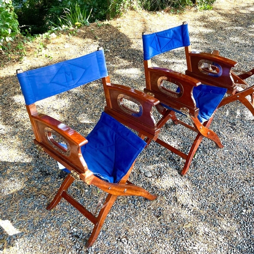 604 - Three teak and brass mounted directors folding chairs, height 87cm. (3)