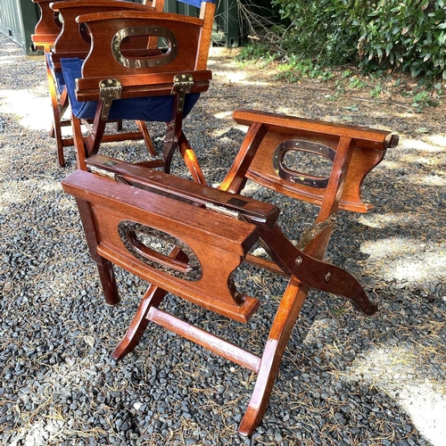 604 - Three teak and brass mounted directors folding chairs, height 87cm. (3)