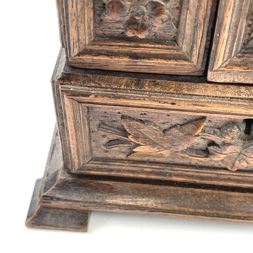 61 - A Black Forest linden wood carved jewellery casket circa 1900 decorated with hops and vine leaves be... 