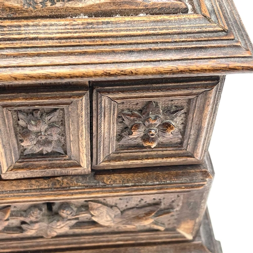 61 - A Black Forest linden wood carved jewellery casket circa 1900 decorated with hops and vine leaves be... 