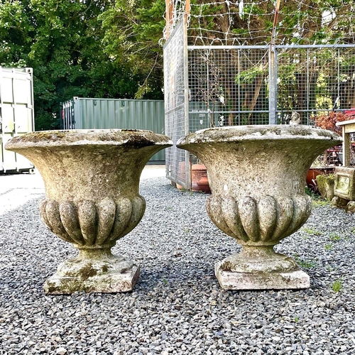 611 - A pair of reconstituted stone garden urns of campana form, height 59cm diameter 63cm