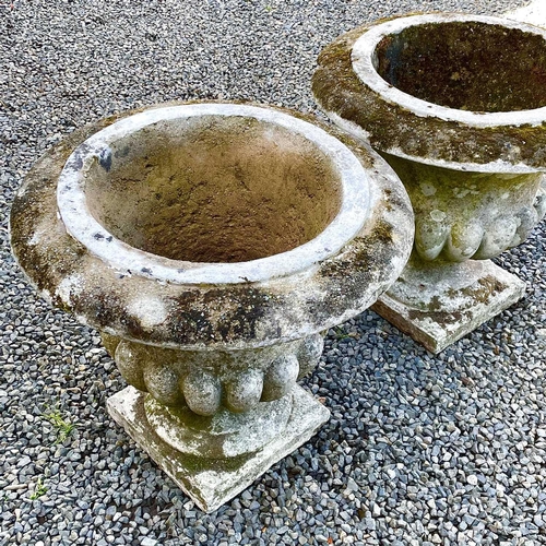 611 - A pair of reconstituted stone garden urns of campana form, height 59cm diameter 63cm