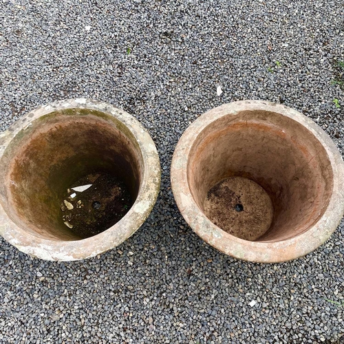 614 - Two matched terracotta urns moulded with floral swags, height 49cm diameter 61.5cm