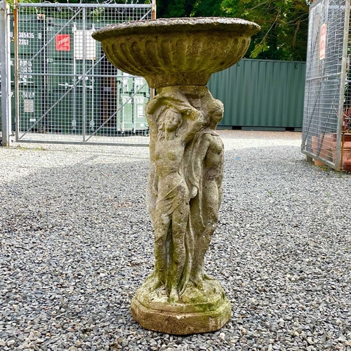 619 - A reconstituted stone garden bird bath the circular top supported bya pedestal base moulded with the... 