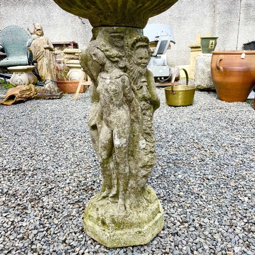 619 - A reconstituted stone garden bird bath the circular top supported bya pedestal base moulded with the... 