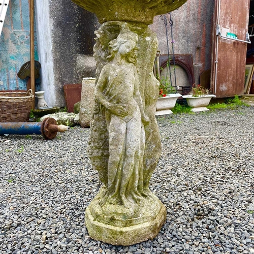 619 - A reconstituted stone garden bird bath the circular top supported bya pedestal base moulded with the... 