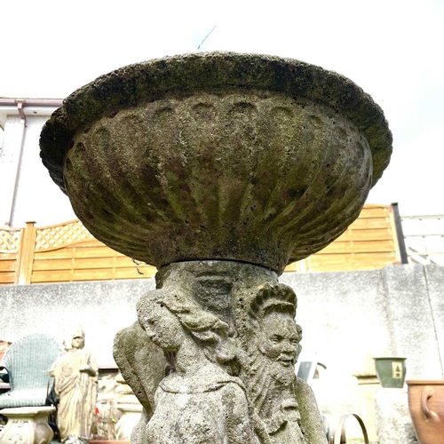 619 - A reconstituted stone garden bird bath the circular top supported bya pedestal base moulded with the... 