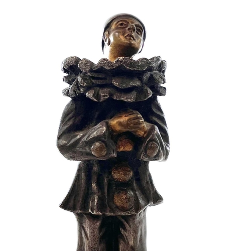 66 - E Benoit, A French Art Deco silvered bronze and gilt figure of Pierrot, on a square onyx base, heigh... 